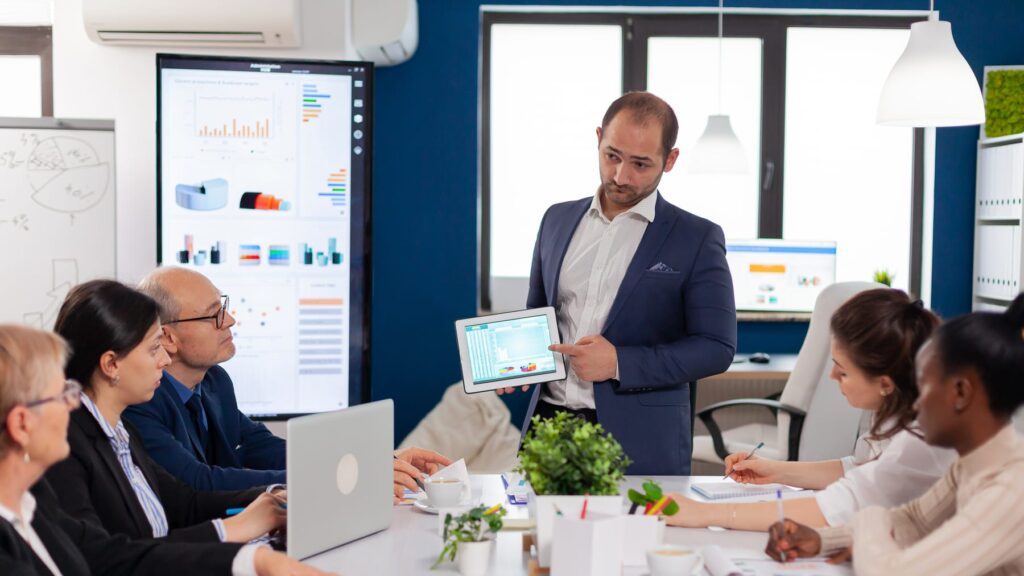 Team leader briefing colleagues in a conference room