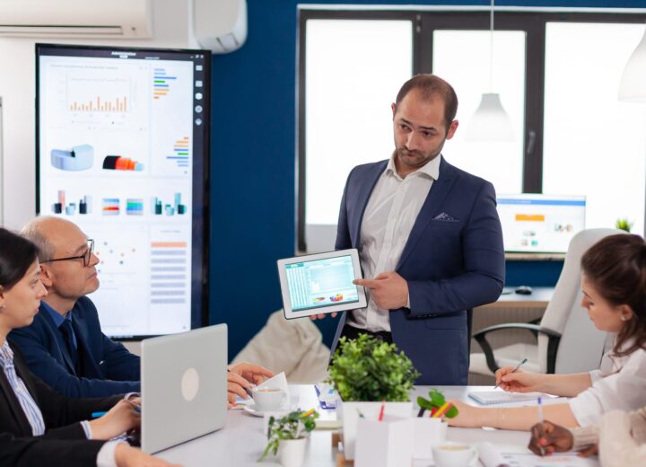 Team leader briefing colleagues in a conference room